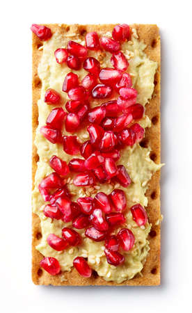 Healthy rye crispbread with cream cheese, peanut butter, banana and pomegranate isolated on white background, top viewの写真素材