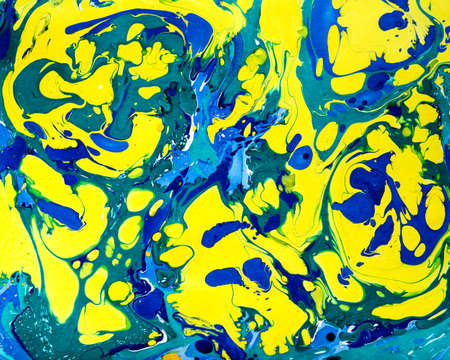 Abstract marbling ebru colorful background with blue and yellow waves and splashes, handmade...
