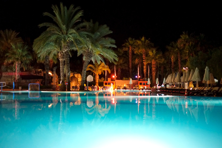 Blue swimming pool at holiday resort at evening time.のeditorial素材