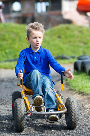 Boy having fun with buggy cart. の写真素材