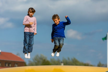 Kids having fun on bouncy cushion. の写真素材