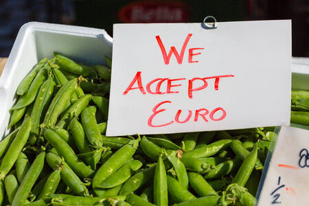 A We Accept Euro sign on top of box with green peas の写真素材