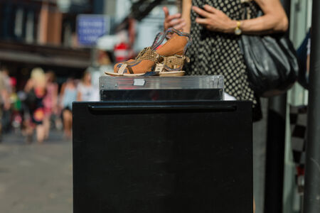 A shoe with high heel on display outside a footwear store.の写真素材