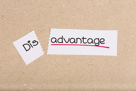 Two pieces of white paper with the word disadvantage turned into advantage
