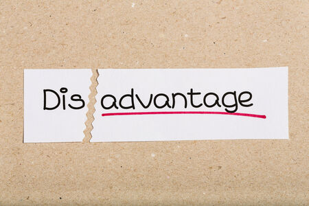 Two pieces of white paper with the word disadvantage turned into advantageの写真素材