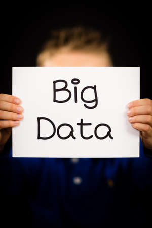 Studio shot of child holding a Big Data sign made of white paper with handwriting.の写真素材