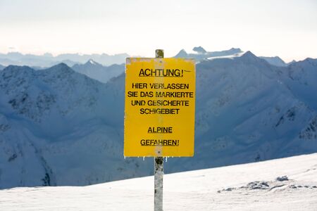 Yellow warning sign at the ski resort Soelden in the Austrian Alps.の写真素材