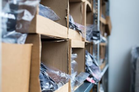 Close-up of cardboard boxes on rack in traditional indoors warehouse.の写真素材