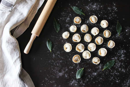 Preparation of pelmeni. Top view. The Ingredients on a black table. Traditional Russian cuisineの写真素材