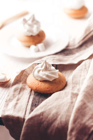Cupcakes with vanilla cream on white wooden backdrop. Vertical compositionの写真素材