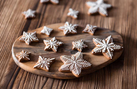 Set of homemade gingerbread on brown wooden background. Christmas cookies in stars shape.の写真素材