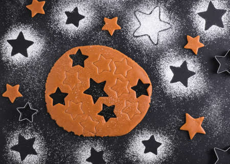 Gingerbread christmas cookies preparation. Top view. The Ingredients on a black table. Starsの写真素材