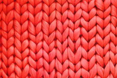 Texture of red wool big knit blanket. Large knitting. Plaid merino wool. Top viewの写真素材