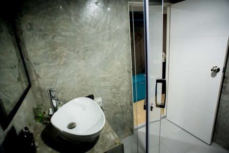 sanitaryware in the little bathroom with wooden floorのeditorial素材
