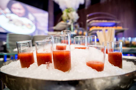 canapes on toothpicks , appetizer, pinchos , spanish food ,delicious finger food,tomato juice glass isolated on iceのeditorial素材