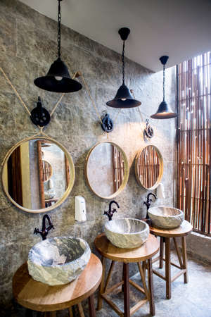 Vintage bathroom with a marble sink, brass faucet and a mirrorのeditorial素材
