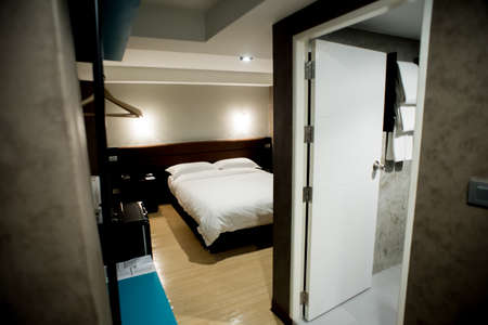 Modern tastefully and simply decorated bedroom of a small hotelのeditorial素材