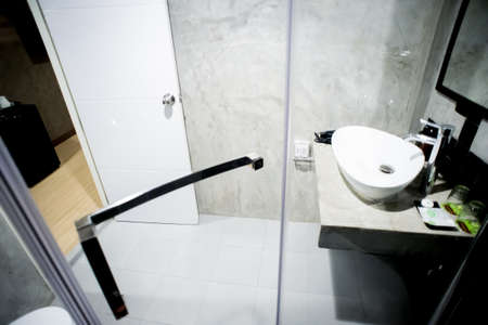 sanitaryware in the little bathroom with wooden floorのeditorial素材