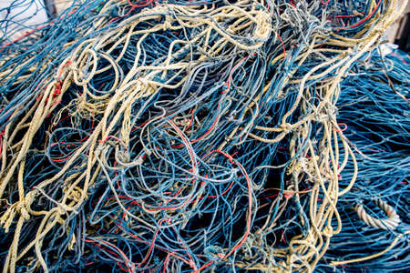 Abstract background with a pile of fishing nets ready to be cast overboard for a new days fishing