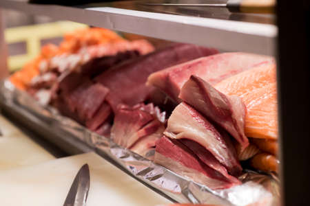 some salmon sashimi in a glass box wait for eatの写真素材