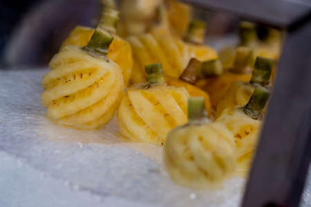 Pineapple in ice box,fruit in cooler,Streetfood close up in the Thailand. Cuted pineapple on the ice in glass boxの写真素材