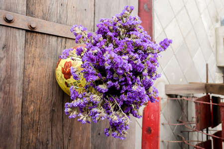Beautiful lilac flowers in vase on table of interior background