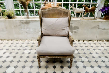 An old abandoned chair left in an abandoned dilapidated building. Interesting how the colors of the building and the chair match- space for copy,Chair of the mortar,black bench with red brick backgroundの写真素材