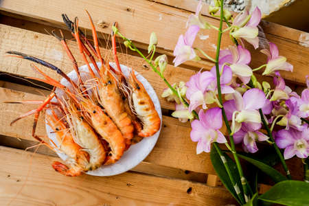 Closeup grilled shrimp on white plate. On wooden table.の写真素材