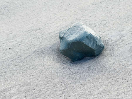Desert surface with emerald boulder, texture. Area in Altai mountains. Cloudy weather, summer.の写真素材