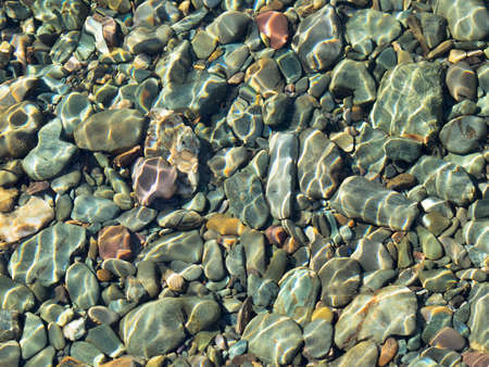 Many underwater stones different forms and color. Daylight, close-up, limestones and some volcanic.