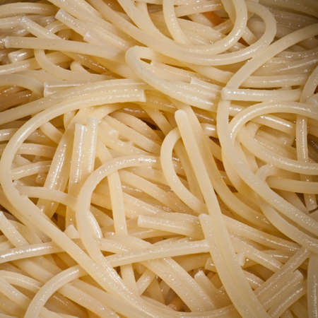 A close-up view of some tangled up cooked spaghetti.の写真素材