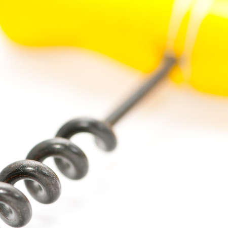 A close-up of a corkscrew spiral, leading to its yellow handle.の写真素材