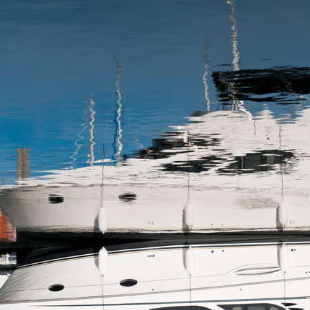 The reflection of a motorboat at the marina.の写真素材