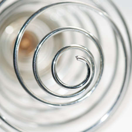 An abstract shot of a metallic whisk.