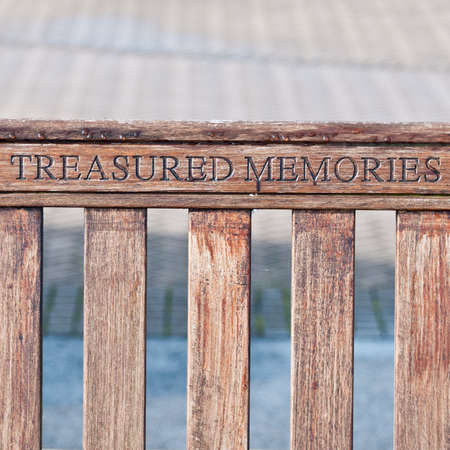A memorial inscription on a bench at the marina.のeditorial素材