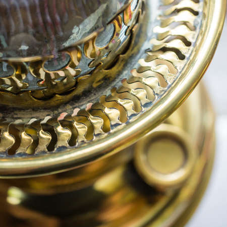 A close-up look at the details of an antique oil lamp 