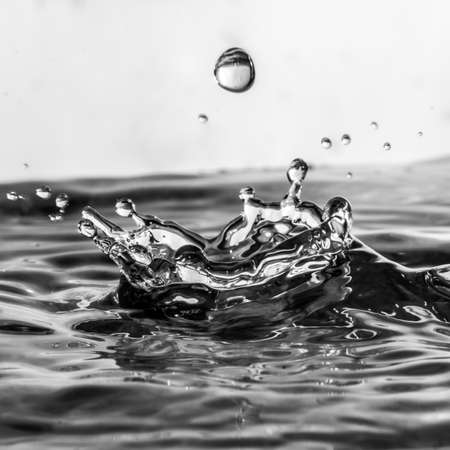 A close-up of water splashing into a bowl の写真素材