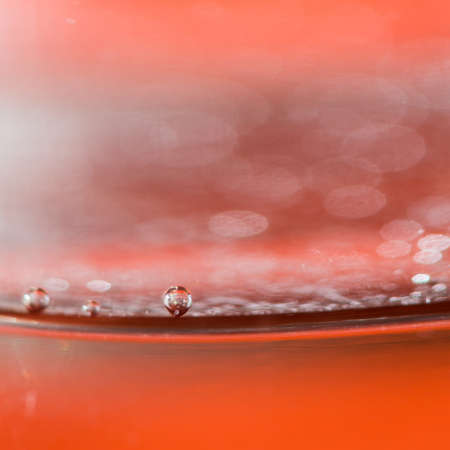 Focussing on a single bubble within a glass of lemonade の写真素材