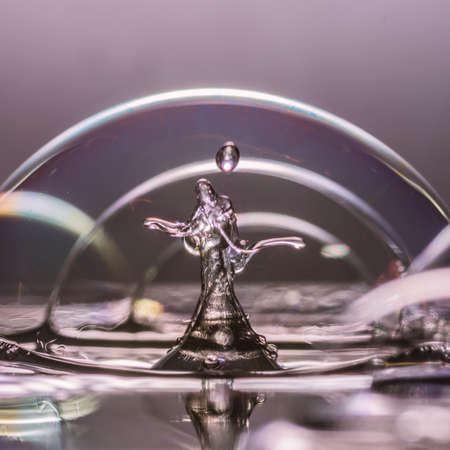 An abstract macro shot of a water drop collision within some bubbles の写真素材