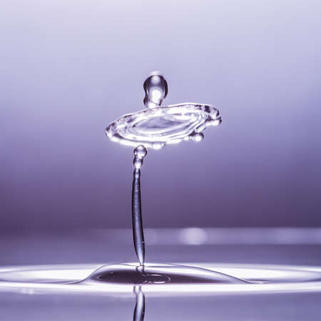 An abstract macro shot of a water drop collision.の写真素材