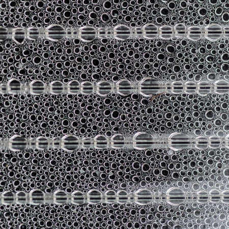 An abstract shot of condensation forming on a glass window 