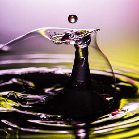 An abstract macro shot of water drops colliding within a soap bubble.の写真素材