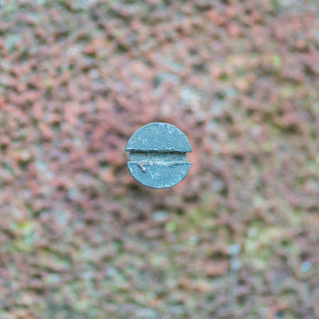 An abstract macro shot of a screw head and a brick.の写真素材