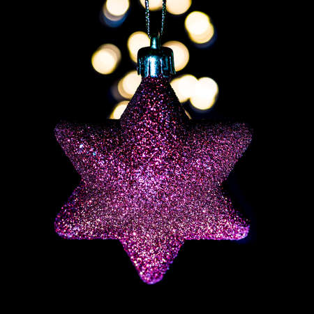 A macro shot of a star shaped Christmas decoration.
