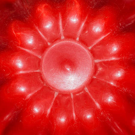 An abstract macro shot of the base of a red jelly mould.の写真素材