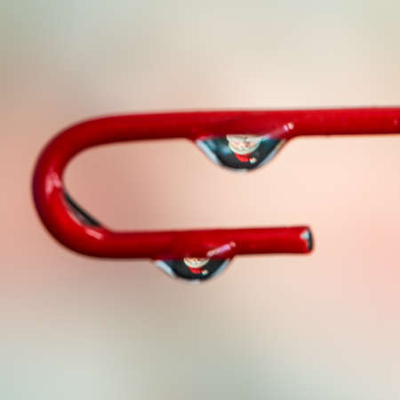 A macro shot of Father Christmas refracted in a water drop.の写真素材