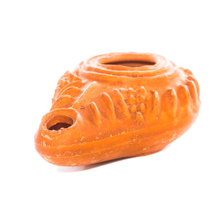 A macro shot of a replica terracotta olive oil lamp from biblical times.の写真素材