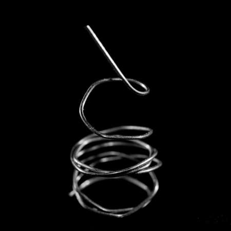 A b&w macro shot of a coiled piece of thin wire.の写真素材