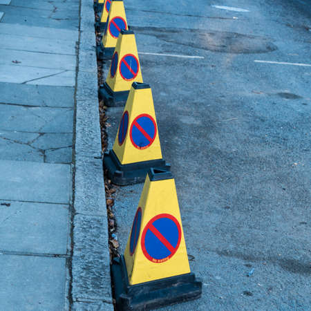 A row of traffic bollards indicating that there is no waiting in this street.の写真素材