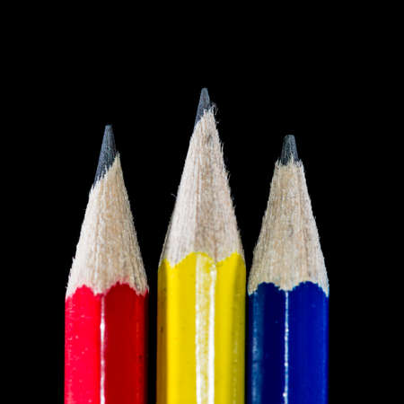 A macro shot of three pencils shot against a black background.の写真素材